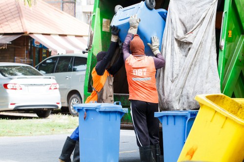 Workers assessing risks during rubbish removal